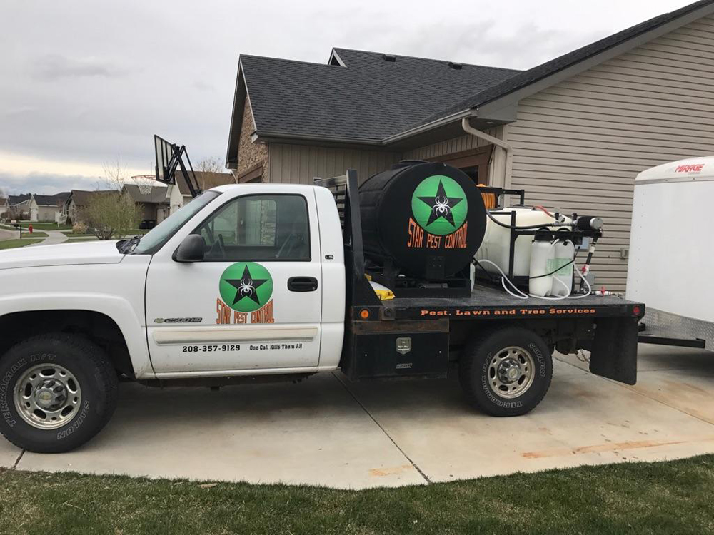 pest control truck with equipment outside of home
